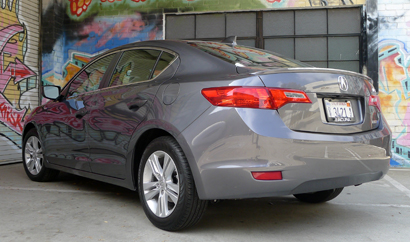 A three-quarter rear view of a 2013 Acura ILX Hybrid