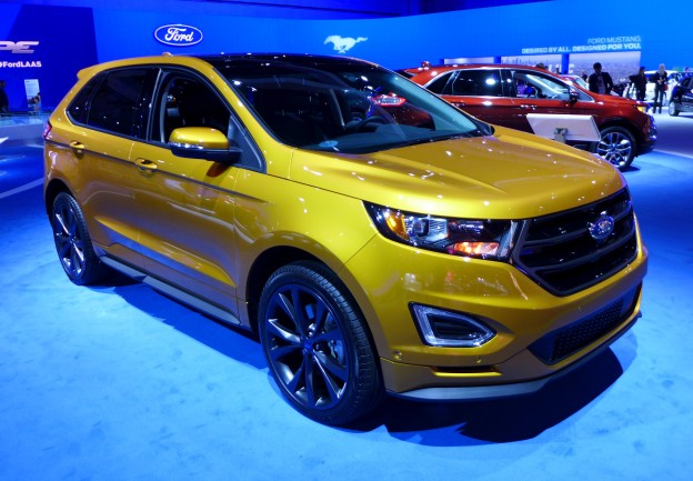 A three-quarter front view of the 2015 Ford Edge Sport AWD in electric spice